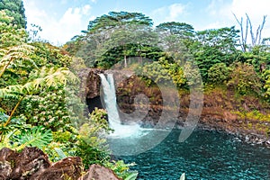 Splendid landscape of the Rainbow Falls waterfall in Hilo, Hawaii surrounded by green vegetation