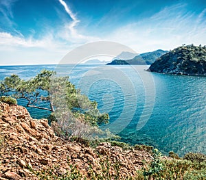 Splendid Mediterranean seascape in Turkey. Sunny view of a small azure bay near the Tekirova village vith Mt. Tahtali on