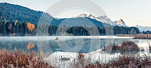 Splendid morning panorama of Wagenbruchsee Geroldsee lake with Zugspitze mountain range on background. Beautiful autumn view of