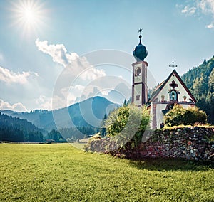 Splendid morning view of San Giovanni Church in St. Magdalena village. Sunny summer scene of Funes Valley Villnob with Odle