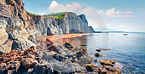 Splendid spring landscape of famous Xi Beach. Sunny morning scene of Cephalonia island, Greece, Europe. Attractive seascape of