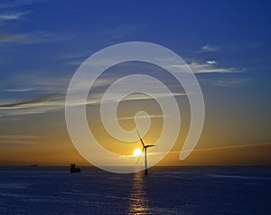 Splendid sunrise with beautiful sky and wind turbine