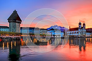 Splendid sunset over the Luzern Kappelbrucke bridge and Jesuten church with Pilatus mountain