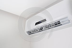 Split air conditioner closeup on white wall in flat indoors