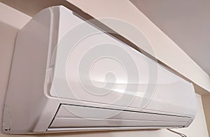 Split air conditioner on a white wall. Closeup image
