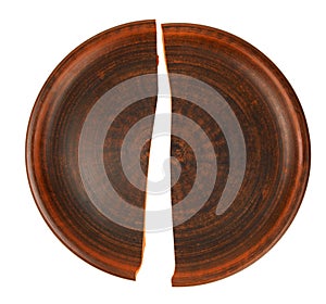 The split clay plate is isolated on a white background. A broken dish