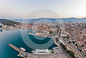 Split, Croatia - Aug 14, 2020: Aerial drone shot of Ferry Port in old town before sunrise in early monring