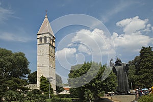 Statue of Gregorius of Nin Grgur Ninski and the Bell-tower of Saint-Rainier Benedictine Monastery, Split, Dalmatia, Croatia.