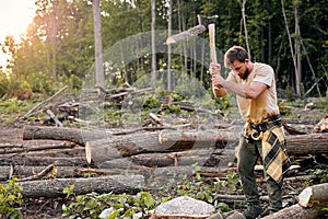 Split and cut. male using Large axe. Splitting axe on natural landscape.