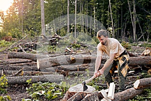 Split and cut. strong male using Large axe. Splitting axe on natural landscape.