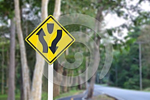 Split direction traffic sign blur background