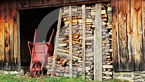 Split Firewood and Wheelbarrow by Old Shed