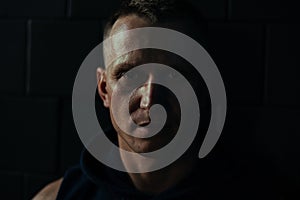 Split light portrait with light and shadow of man