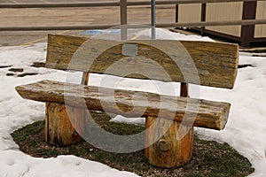 Split log work park bench in the winter