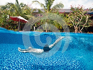 Split photo of a man underwater in the swimming pool in the holiday villa