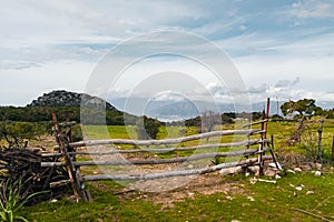 A split rail fence along a countryside field.