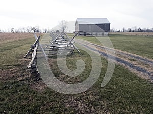 Split rail fence alongside road to barn