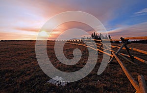 Split Rail Fence at sunrise above Lost Water Canyon in the Pryor Mountains Wild Horse range on the Montana Wyoming state line