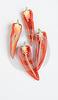 Split Red Peppers with Seeds and Pulp on White Background