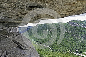 A split rock frames a mountain on Chimney Rock.