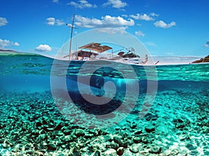 Split view - half underwater view of beautiful seabed with sea fishes and beautiful marine yacht, Turkey, Bodrum photo