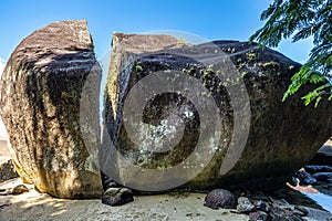 Splitted stone at Abraao Preta beach on big island Ilha Grande in Angra dos Reis, Rio de Janeiro, Brazil photo