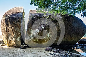 Splitted stone at Abraao Preta beach on big island Ilha Grande in Angra dos Reis, Rio de Janeiro, Brazil photo