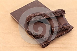 Splitted up block of the dark aerated chocolate close-up