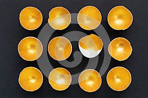 Splurge concept. Golden eggshell isolated on black background. Glamorous eggs. Creative Easter design template for advertising