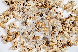 Spoiled burnt grains of popcorn close-up. natural background