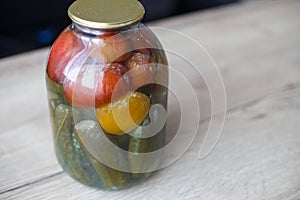 Spoiled can of vegetable seaming. Glass jar with homemade pickled tomatos and cucumbers with white fungus