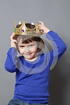 Spoiled kid concept for 4-year old child with crooked golden crown on