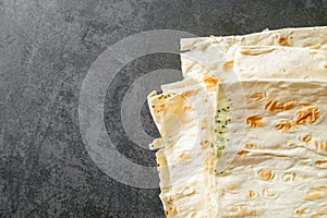 Spoiled pita, moldy. Mildew on the bread. Gray background. copy space.