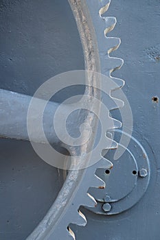 Spoke and teeth of large gray painted iron gear