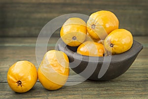 Spondias purpurea - Delicious tropical fruit - Wood background