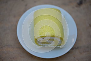 Sponge cake cream roll on white dish