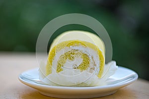 Sponge cake cream roll on white dish