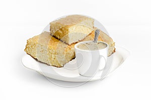 Sponge cake and a cup of coffe on white background