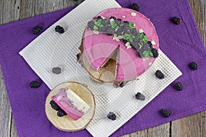 sponge cake with distinctive pink blackberry mousse and almonds