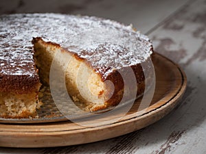 Sponge cake of lemon over wooden background