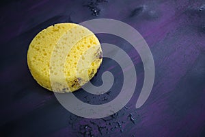 Sponge on Canvas Applying texture with black and purple paint. photo