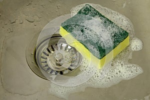Sponge with foam in kitchen sink