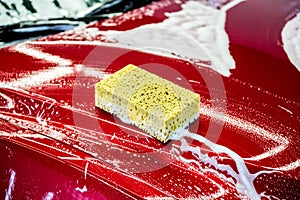 Sponge over the red car for washing.