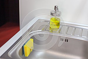 Sponge for washing dishes. Storage ideas, sink in the kitchen.