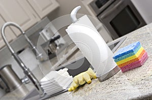 Sponges, paper towels, gloves, cloths in kitchen f photo