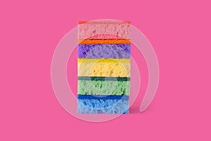Sponges for washing dishes on a bright pink background.