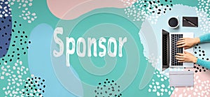 Sponsor with person using laptop