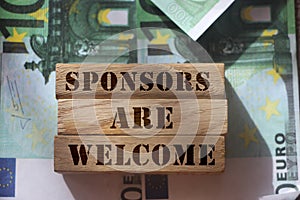 SPONSORS are WELCOME Know Your Worth on wooden blocks pur on 100 Euro banknotes. Sponsorship donation support business startup photo