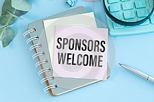 SPONSORS WELCOME text on paper with calculator, notepad, coffee ,pen with graph