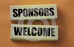 SPONSORS WELCOME on wooden blocks. Sponsorship donation business concept.